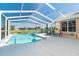 Sparkling swimming pool and spa, surrounded by a screened enclosure with a serene view of the outdoor scenery at 6 Windward Ct, Placida, FL 33946