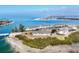 Aerial view showcasing condos surrounded by pristine beach and tranquil water, a coastal paradise at 6000 Boca Grande Cswy # D38, Boca Grande, FL 33921
