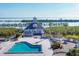 Aerial view featuring a house, pool, spa, deck, and waterfront access with docking facilities at 6000 Boca Grande Cswy # D38, Boca Grande, FL 33921