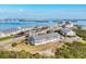 Breathtaking aerial view of beachfront condos, showcasing their prime location with stunning water views at 6000 Boca Grande Cswy # D38, Boca Grande, FL 33921