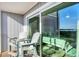 Inviting balcony with chairs, sliding glass doors, and serene water views at 6000 Boca Grande Cswy # D38, Boca Grande, FL 33921
