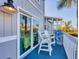 Balcony with blue flooring and white chairs/table set and beach-themed decor at 6000 Boca Grande Cswy # D38, Boca Grande, FL 33921