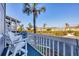 View from the balcony of a condo showing chairs, trees, and a multi-story residential building at 6000 Boca Grande Cswy # D38, Boca Grande, FL 33921