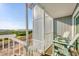 Balcony with seating overlooking lush greenery and serene water views on a sunny day at 6000 Boca Grande Cswy # D38, Boca Grande, FL 33921