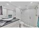 Well-lit bathroom featuring double vanity with granite counters and a large tiled shower at 6000 Boca Grande Cswy # D38, Boca Grande, FL 33921