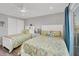 Bright bedroom with two twin beds, closet space, and a sliding glass door to balcony at 6000 Boca Grande Cswy # D38, Boca Grande, FL 33921