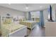 Bedroom featuring two twin beds, balcony access and cool coastal decor at 6000 Boca Grande Cswy # D38, Boca Grande, FL 33921