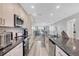 Modern kitchen with granite counters opens to living space and beautiful views at 6000 Boca Grande Cswy # D38, Boca Grande, FL 33921