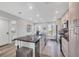 Bright eat-in kitchen featuring gray cabinets, stainless appliances, and hardwood floors at 6000 Boca Grande Cswy # D38, Boca Grande, FL 33921