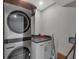 Laundry room with stacked washer/dryer, counter space, and storage cabinets at 6000 Boca Grande Cswy # D38, Boca Grande, FL 33921