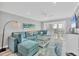 Bright living room featuring comfortable seating, modern decor, and access to a waterfront balcony at 6000 Boca Grande Cswy # D38, Boca Grande, FL 33921