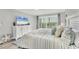 Bright main bedroom with a sliding glass door to the balcony, TV and coastal decor at 6000 Boca Grande Cswy # D38, Boca Grande, FL 33921