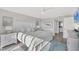 A bright main bedroom featuring a plush rug, neutral paint, and a large TV at 6000 Boca Grande Cswy # D38, Boca Grande, FL 33921