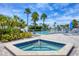 Community pool and hot tub with comfortable lounge chairs surrounded by tropical landscaping at 6000 Boca Grande Cswy # D38, Boca Grande, FL 33921