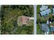 An aerial view of a charming house that features mature trees and landscaping in a quiet residential neighborhood at 6368 Pennell St, Englewood, FL 34224