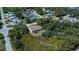 The exterior showcases the home's backyard with a well-maintained lawn, mature trees, and a red deck at 6368 Pennell St, Englewood, FL 34224