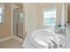 Bathroom with soaking tub and glass enclosed shower at 6368 Pennell St, Englewood, FL 34224