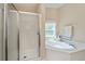 Bathroom featuring soaking tub and glass enclosed shower at 6368 Pennell St, Englewood, FL 34224