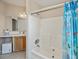 Functional bathroom with a tub-shower combo, vanity, and soft, natural lighting at 6368 Pennell St, Englewood, FL 34224