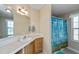 Well-lit bathroom with a vanity, sink, mirror, and a charming shower curtain at 6368 Pennell St, Englewood, FL 34224