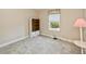 Light-filled bedroom with a window view, soft carpet, and a built-in bookcase at 6368 Pennell St, Englewood, FL 34224