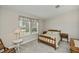 Bright bedroom with window, featuring a comfortable bed and matching side tables at 6368 Pennell St, Englewood, FL 34224