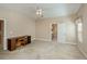 Neutral bedroom showing view to bathroom, with carpet, ceiling fan, and built-in desk at 6368 Pennell St, Englewood, FL 34224