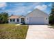 Charming single-story home with a two-car garage, well-manicured lawn, and inviting curb appeal at 6368 Pennell St, Englewood, FL 34224