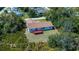 The exterior showcases the home's backyard with a well-maintained lawn, mature trees, and a red deck at 6368 Pennell St, Englewood, FL 34224