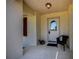Inviting front porch with chair and plants near the glass paneled front door at 6368 Pennell St, Englewood, FL 34224
