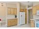Kitchen with a breakfast bar, modern white appliances, and light-colored cabinets at 6368 Pennell St, Englewood, FL 34224