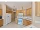 Clean kitchen featuring modern appliances, tile floors, and warm wooden cabinets at 6368 Pennell St, Englewood, FL 34224