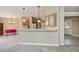 Open-concept living space featuring a breakfast bar that connects to the dining area at 6368 Pennell St, Englewood, FL 34224