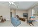Spacious living room with plush carpeting, ceiling fan, and comfortable seating arrangement at 6368 Pennell St, Englewood, FL 34224