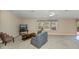 Expansive living room featuring plush carpeting, large windows, and comfortable seating at 6368 Pennell St, Englewood, FL 34224