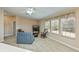 Bright living room featuring carpeted floors, neutral walls, and a comfortable seating arrangement at 6368 Pennell St, Englewood, FL 34224