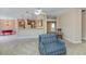 Open-concept living area with plush carpeting and views into kitchen and foyer at 6368 Pennell St, Englewood, FL 34224