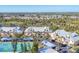 Aerial view of the condo community showcasing multiple buildings, tennis courts, landscaping, and parking areas at 6610 Gasparilla Pines Blvd # 113, Englewood, FL 34224