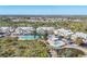 Aerial view of the condo community showcasing the buildings, amenities, tennis courts, pool, and landscaping at 6610 Gasparilla Pines Blvd # 113, Englewood, FL 34224
