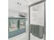 Shower with decorative tile, frosted sliding door, and built-in storage for toiletries and towels at 6610 Gasparilla Pines Blvd # 113, Englewood, FL 34224