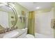 Bathroom featuring granite countertop vanity, chrome finishes, and a shower-tub combination at 6610 Gasparilla Pines Blvd # 113, Englewood, FL 34224