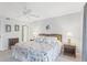 Well-lit bedroom with ceiling fan, two side tables with lamps, and decor art on the wall at 6610 Gasparilla Pines Blvd # 113, Englewood, FL 34224