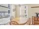 Bright dining area with round wooden table and views of the outdoors at 6610 Gasparilla Pines Blvd # 113, Englewood, FL 34224