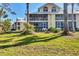 Spacious condo building featuring screened balconies and lush green lawn at 6610 Gasparilla Pines Blvd # 113, Englewood, FL 34224
