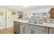 Beautiful kitchen with an open layout to the living room and stainless appliances at 6610 Gasparilla Pines Blvd # 113, Englewood, FL 34224