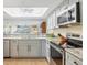 Bright, updated kitchen with granite countertops and stainless steel appliances at 6610 Gasparilla Pines Blvd # 113, Englewood, FL 34224