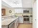 Bright, updated kitchen with granite countertops and stainless steel appliances at 6610 Gasparilla Pines Blvd # 113, Englewood, FL 34224