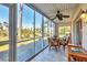 Comfortable lanai features beautiful views of surrounding nature and bright sunshine at 6610 Gasparilla Pines Blvd # 113, Englewood, FL 34224