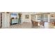 Open-concept living area featuring tile floors, entertainment center, and views of the pool and outdoor area at 6610 Gasparilla Pines Blvd # 113, Englewood, FL 34224