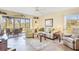 Bright and inviting living room features comfortable seating, a ceiling fan, and a screened-in porch at 6610 Gasparilla Pines Blvd # 113, Englewood, FL 34224